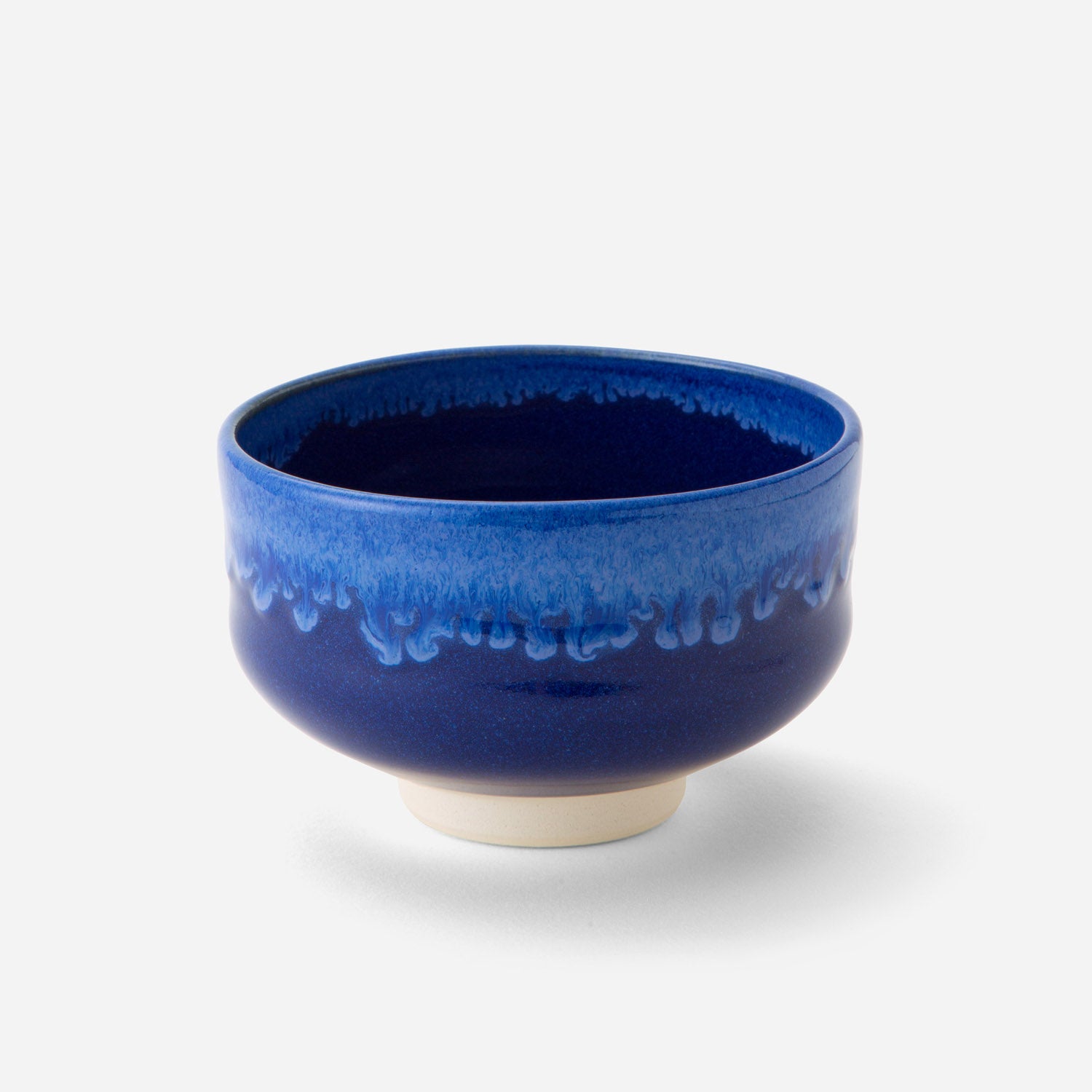 Handcrafted Japanese matcha bowl with deep celestial blue glaze, showcasing a smooth transition from dark to light blue hues reminiscent of a starry night sky