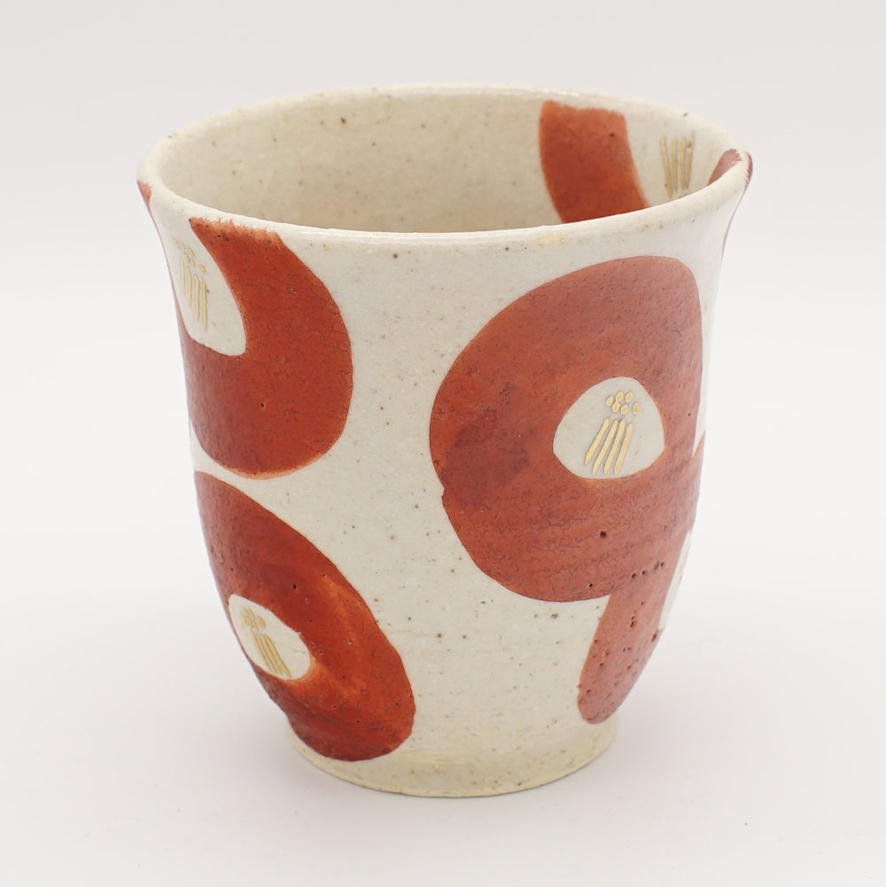 Creamy white Shino tea cup with bold crimson camellia-inspired brushstrokes and gold accents, showcasing modern Japanese ceramic artistry