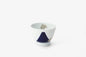 Elegant white porcelain wine cup with deep blue Mt. Fuji design and white gold crest detailing, showcasing modern Japanese craftsmanship