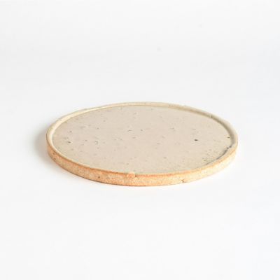 Handcrafted large Koshinraku round ceramic plate with subtle white glaze and natural clay rim, showcasing traditional Japanese pottery techniques