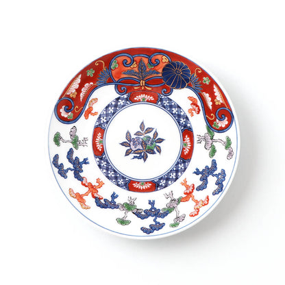 Handcrafted Japanese 16cm plate featuring an intricate pine design with vibrant red and blue patterns, central floral motif, and stylized pine branches on a white background