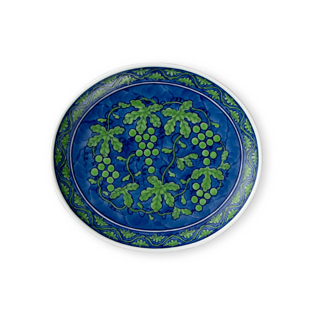 Large handcrafted Japanese oval platter featuring intricate green grapevine design on deep blue background, perfect for serving and display