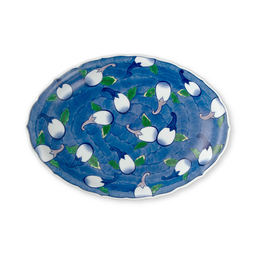 Large handcrafted Japanese oval platter featuring intricate white eggplant blossom design on deep blue background, perfect for serving and display