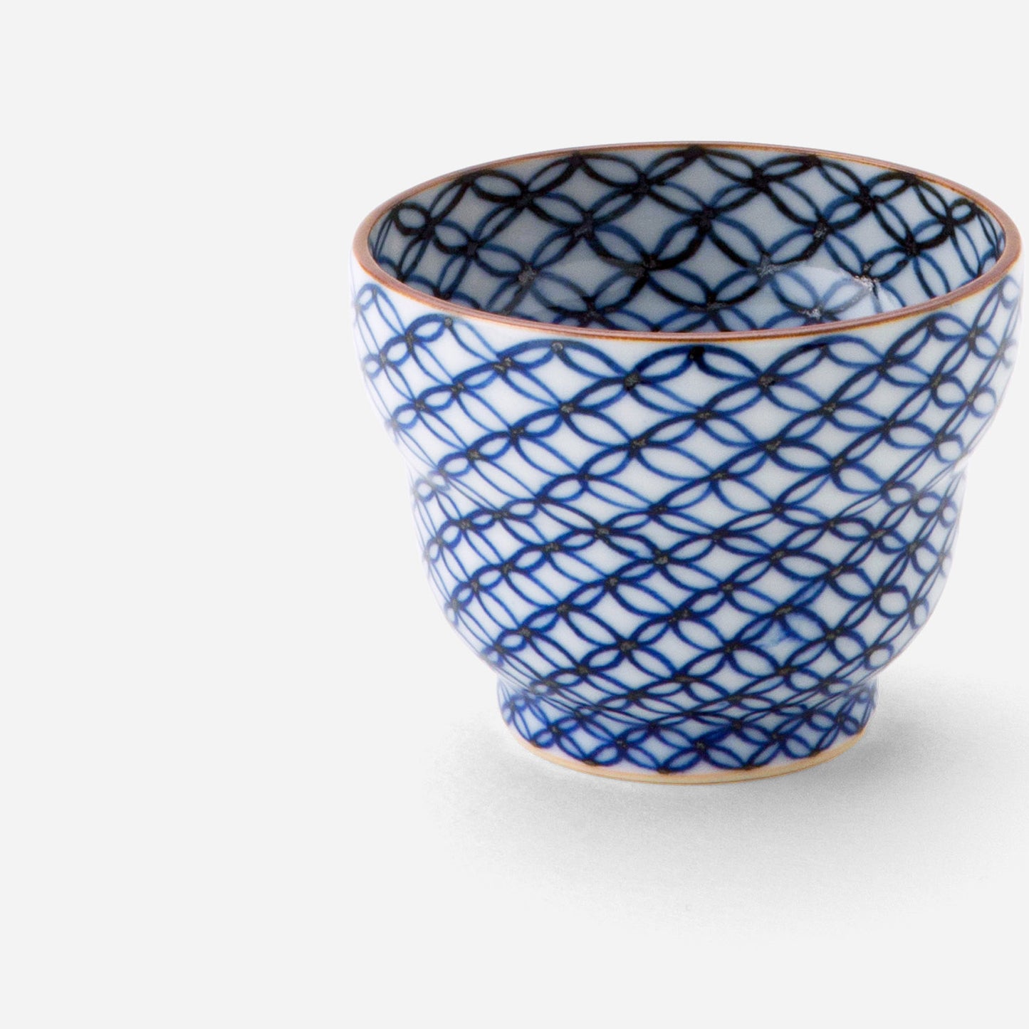 Handcrafted Japanese sake cup with blue sometsuke shippo pattern, featuring an intricate design of overlapping circles in cobalt blue on a white background with a copper-colored rim