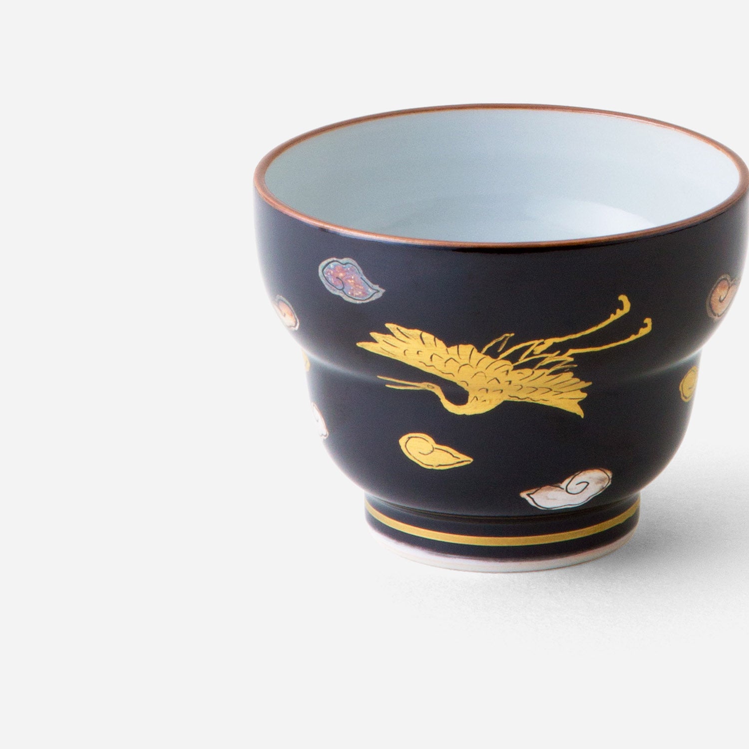 Handcrafted Japanese sake cup with black glaze and gold crane motif, featuring an elegant golden crane design and abstract patterns on a deep black background