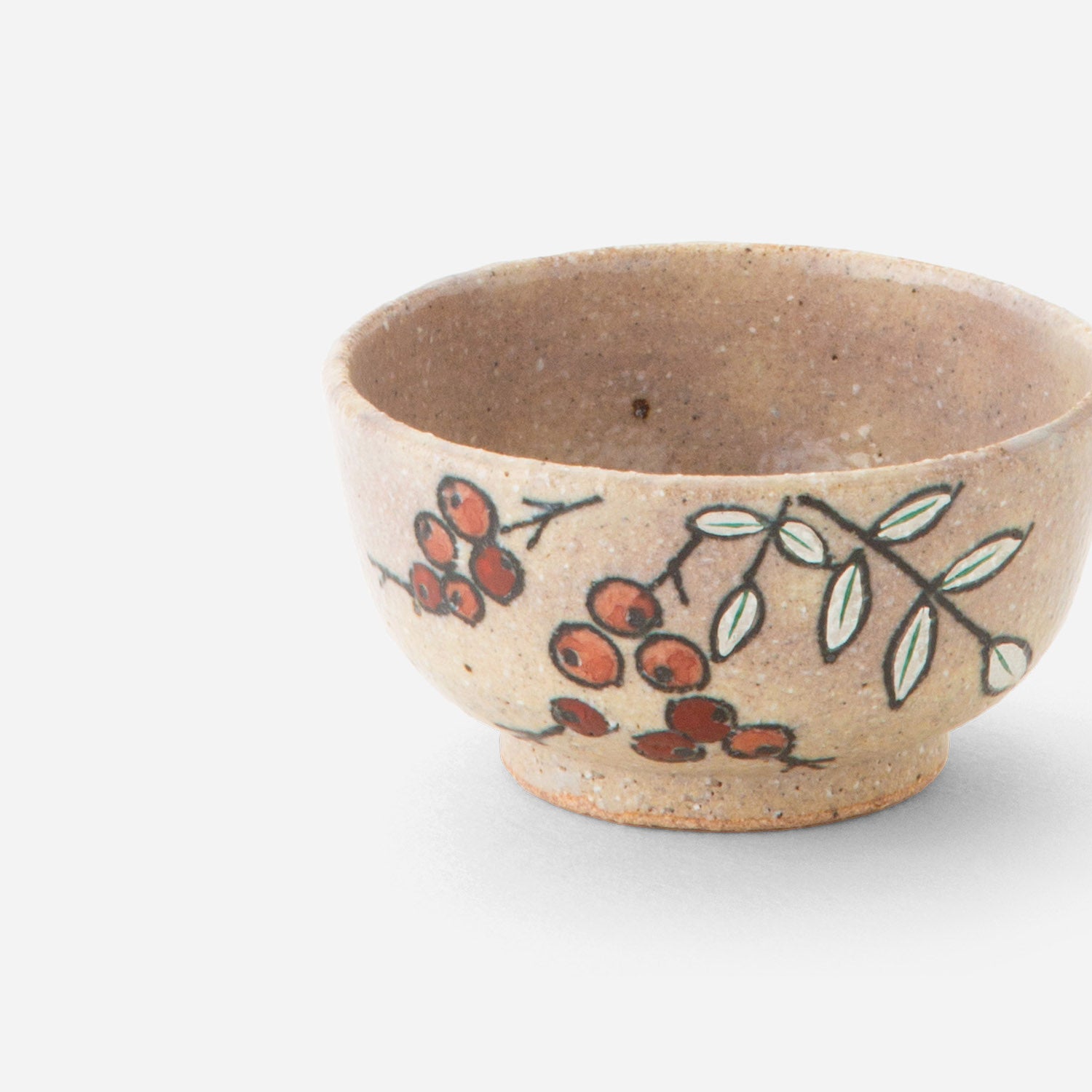 Handcrafted Japanese sake cup with nanten berry design, featuring delicate red berries and green leaves hand-painted on a warm, earthy base