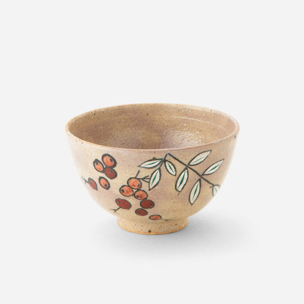 Handcrafted Japanese tea bowl with nanten berry design, featuring delicate red berries and green leaves hand-painted on a warm, earthy base