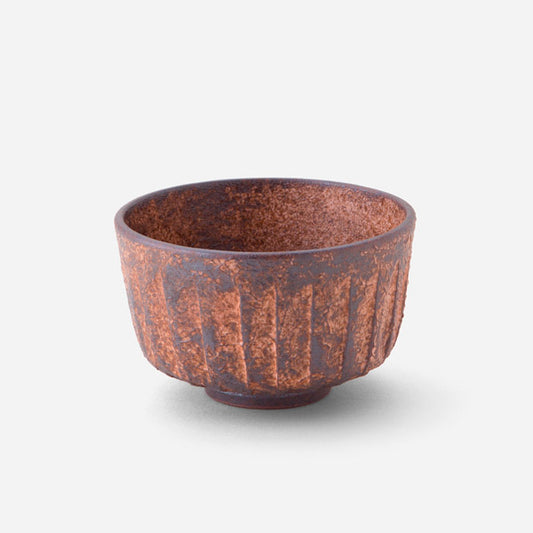 Handcrafted Japanese matcha bowl with rustic sogi (fluted) pattern, featuring a rich reddish-brown glaze reminiscent of sun-baked earth