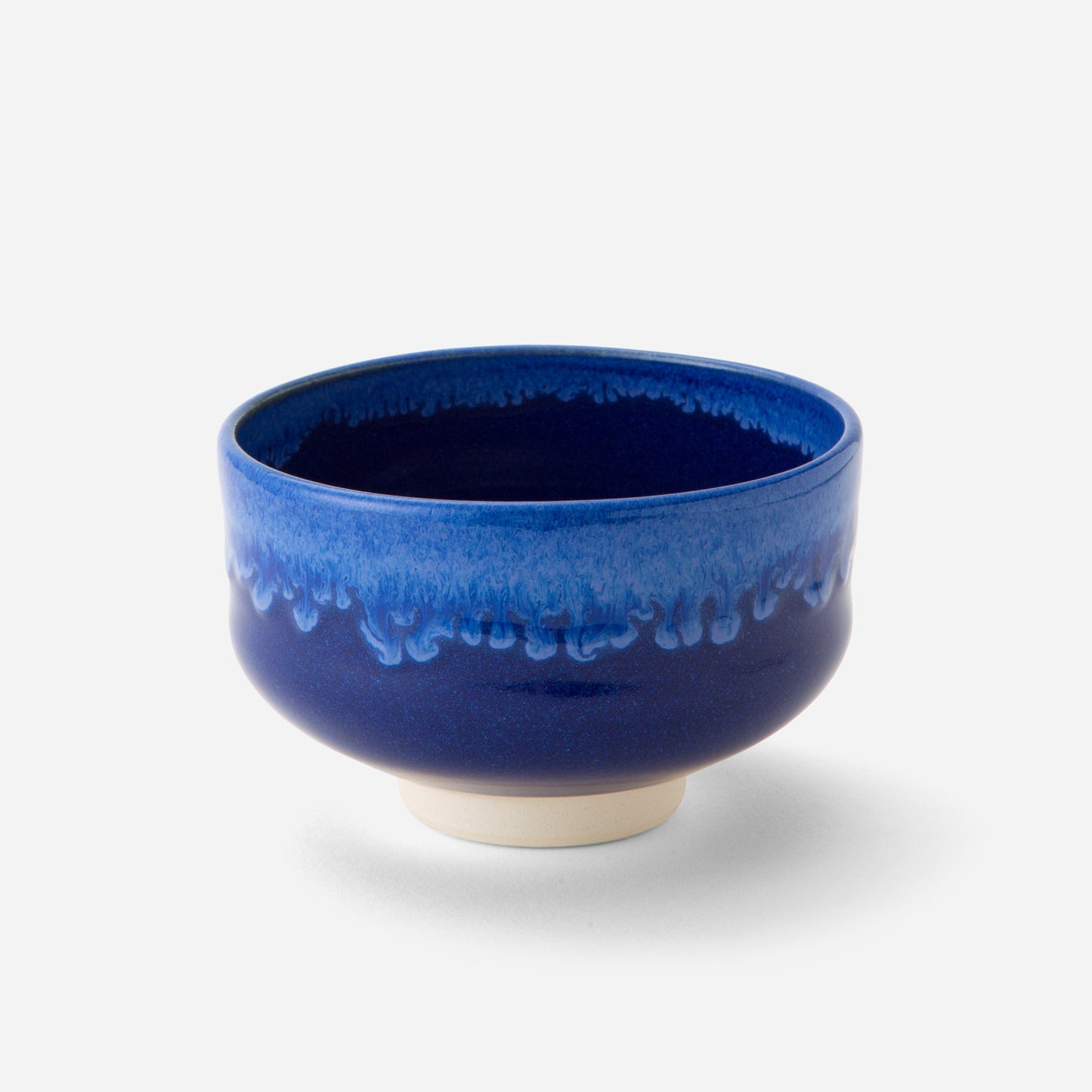 Handcrafted Japanese matcha bowl with deep celestial blue glaze, showcasing a smooth transition from dark to light blue hues reminiscent of a starry night sky