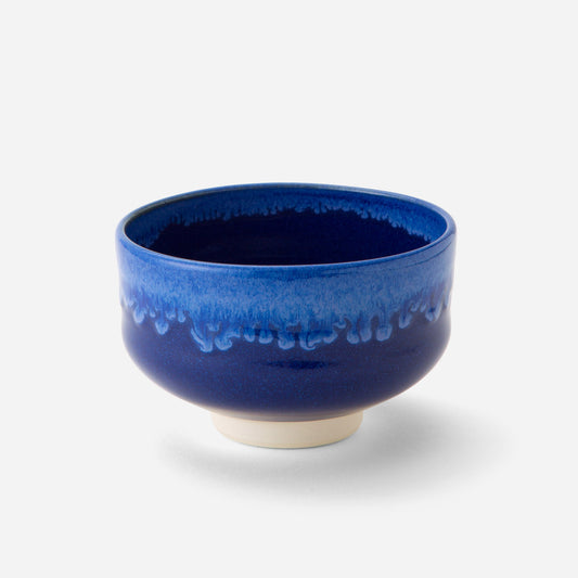 Handcrafted Japanese matcha bowl with deep celestial blue glaze, showcasing a smooth transition from dark to light blue hues reminiscent of a starry night sky