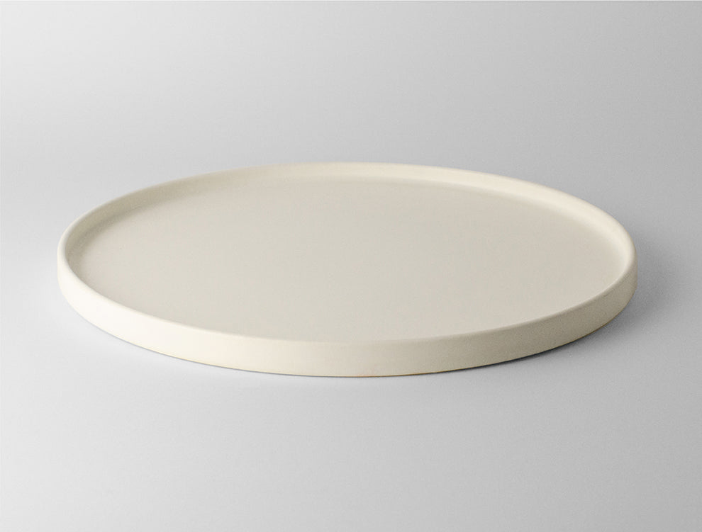 Lotus Large Ceramic Serving Plate in Soft White, showcasing minimalist design for elegant dining