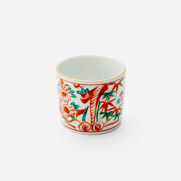 Guiko Saishiki Akae sake cup with vibrant hand-painted floral and bamboo designs, part of a complete Japanese dinnerware set