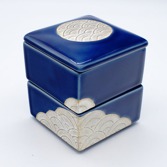 Set of square deep blue ceramic boxes with silver wave patterns, featuring stackable design and fitted lids for elegant storage