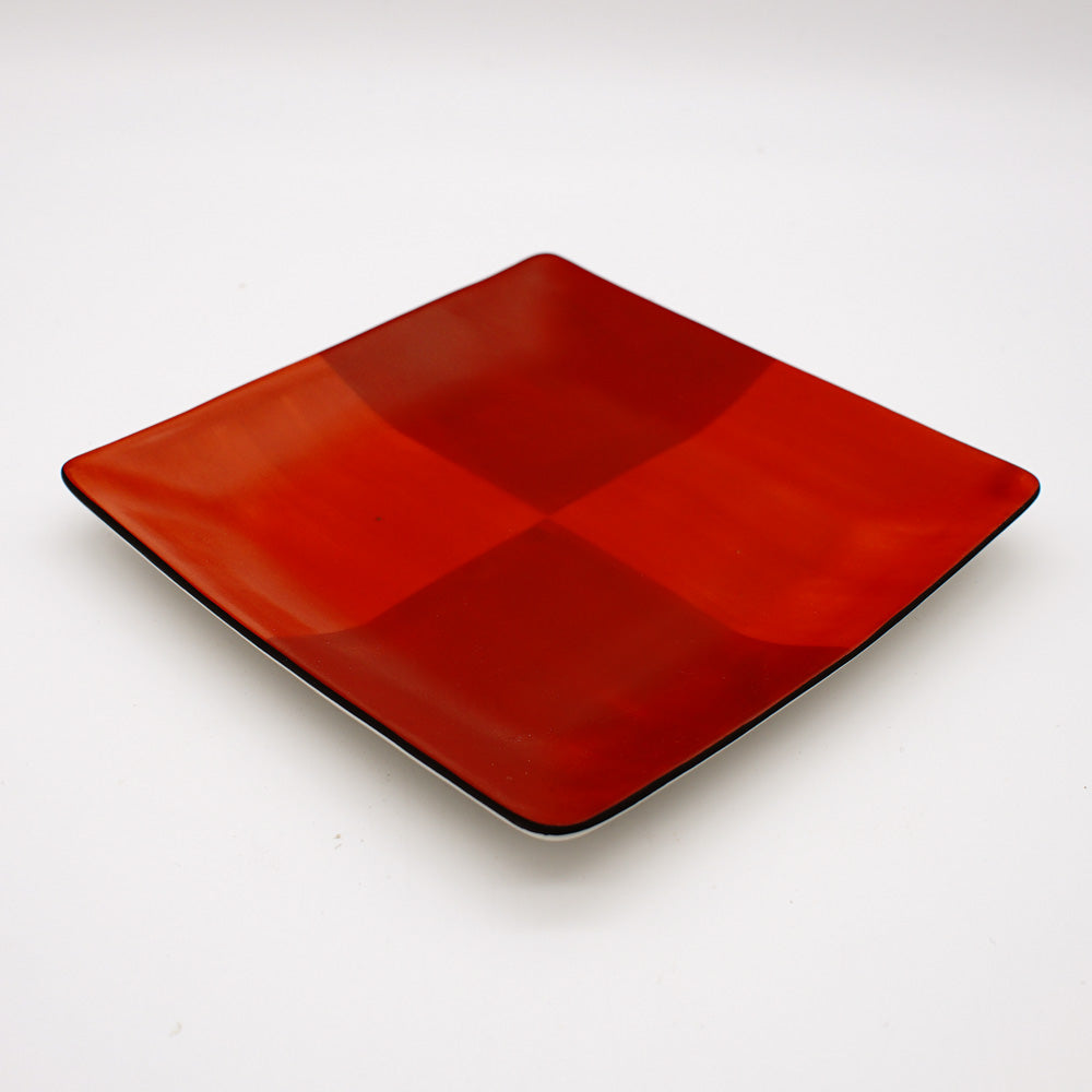 Angular ceramic plate with vibrant red layered checkered pattern and white rim, showcasing modern Japanese-inspired design