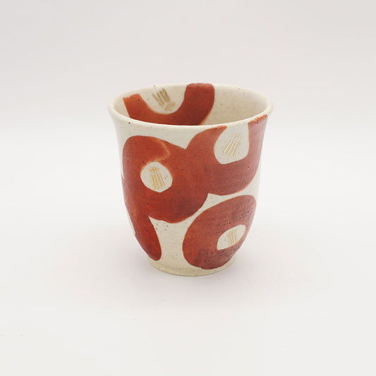 Creamy white Shino tea cup with bold crimson camellia-inspired brushstrokes and gold accents, showcasing modern Japanese ceramic artistry